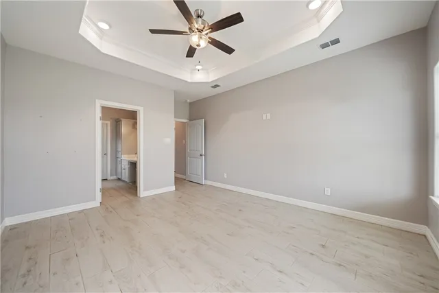 an empty room with fan and a ceiling fan