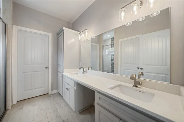 a bathroom with a sink double vanity and a mirror