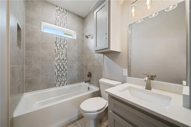 a bathroom with a sink a toilet and a bathtub