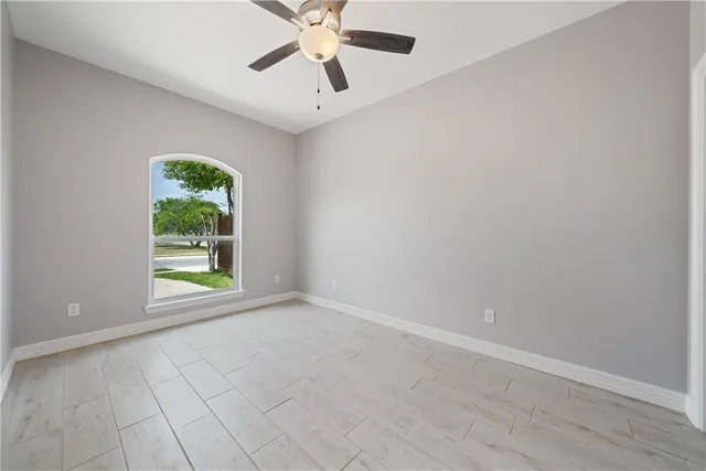 an empty room with windows and closet
