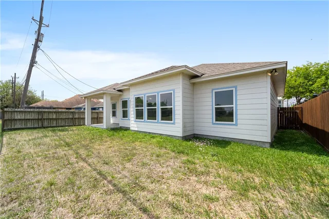 a view of a house with a backyard