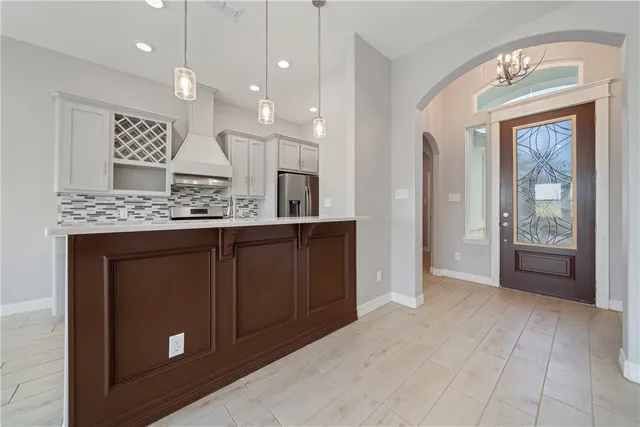 a view of a kitchen counter space and a front door