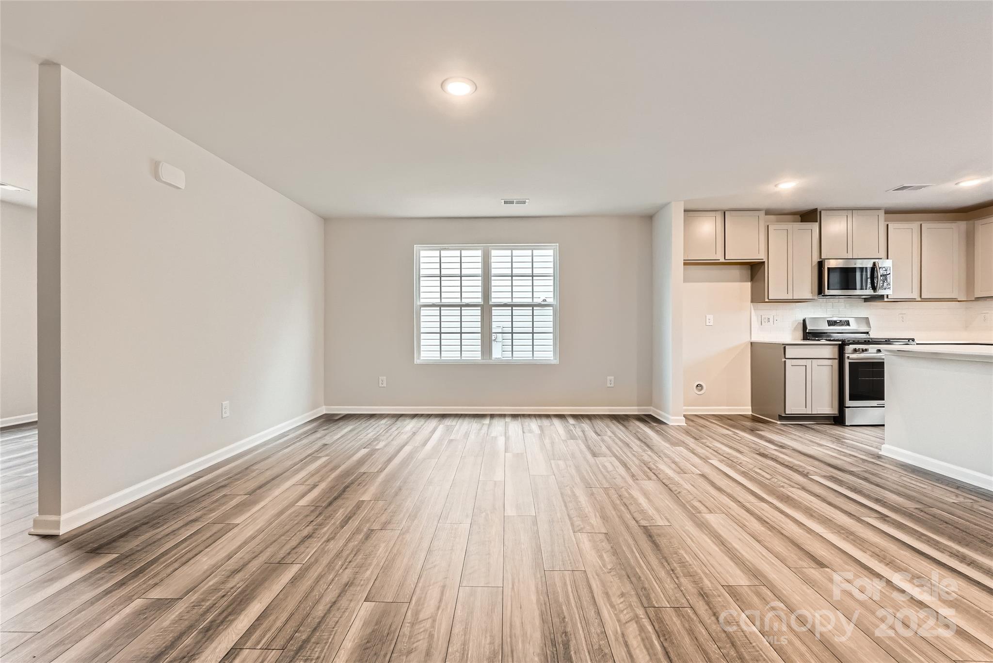 1187 Blackburn Circle Edgemoor, SC 29712 - Photo 4 of 14 an empty room with wooden floor and windows