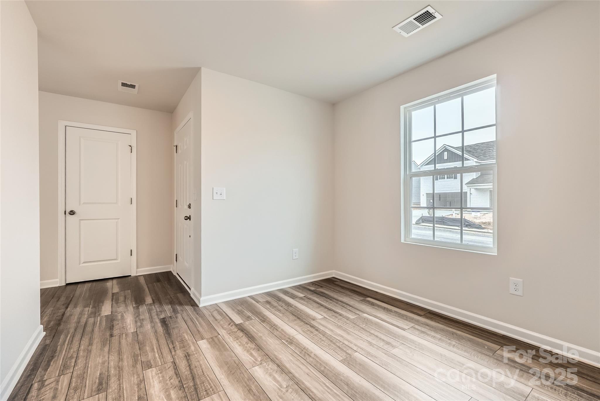1187 Blackburn Circle Edgemoor, SC 29712 - Photo 7 of 14 a view of empty room with wooden floor and fan
