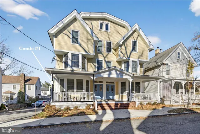 a front view of a residential apartment building with a yard