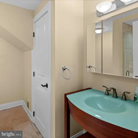 a bathroom with a sink vanity and tub