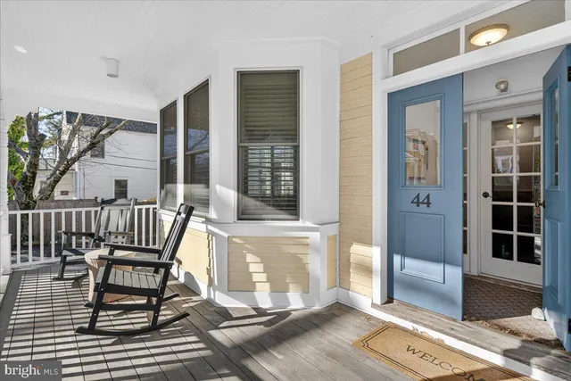 a view of a balcony with two chairs and a potted plant