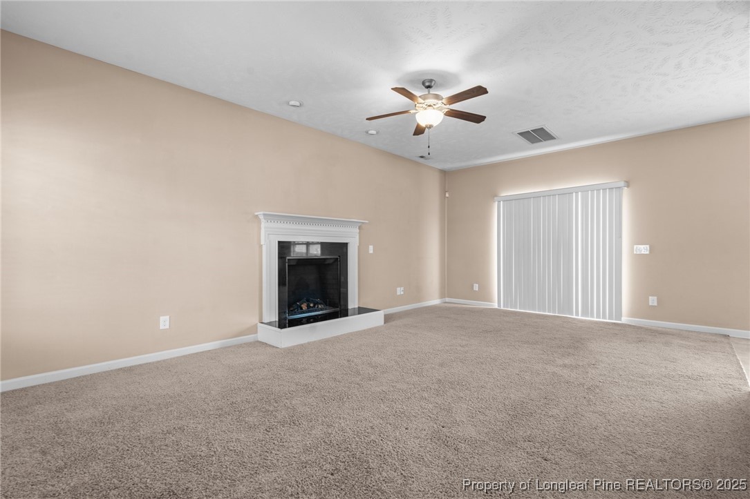 43 Battery Way Bunnlevel, NC 28323 - Photo 16 of 50 a view of an empty room with a fireplace