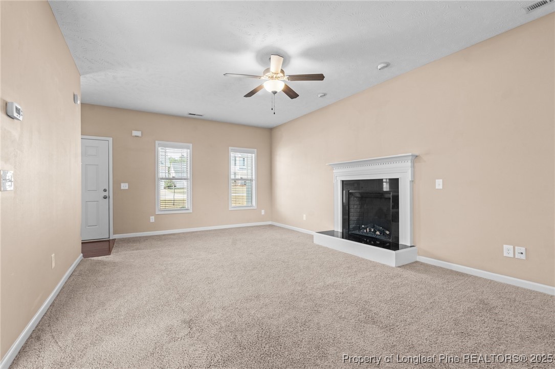43 Battery Way Bunnlevel, NC 28323 - Photo 18 of 50 an empty room with windows and fireplace