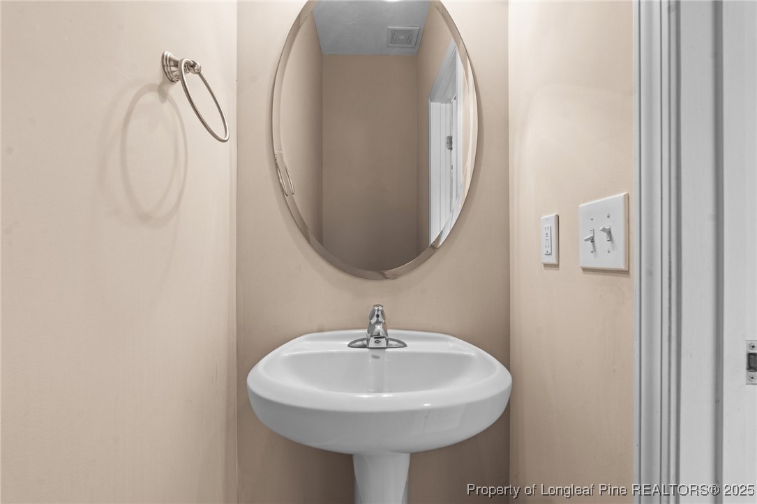 43 Battery Way Bunnlevel, NC 28323 - Photo 23 of 50 a bathroom with a sink and a mirror