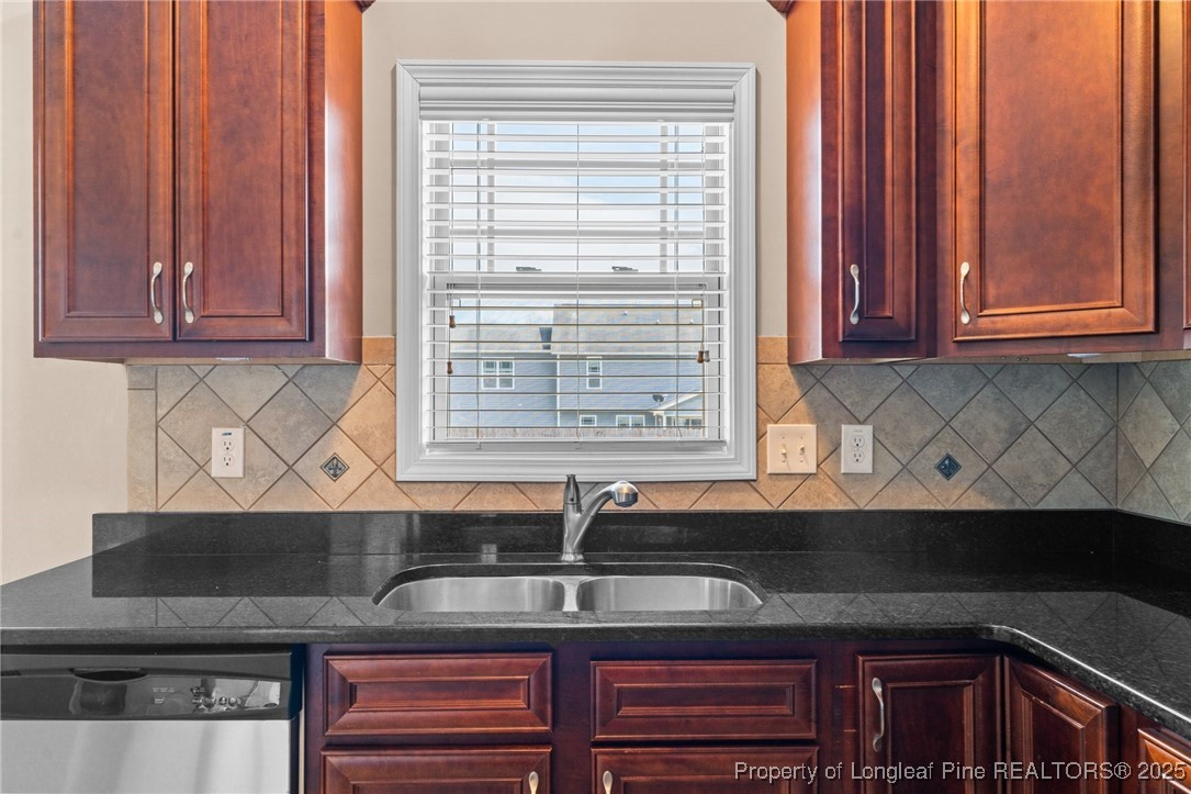 43 Battery Way Bunnlevel, NC 28323 - Photo 27 of 50 a kitchen with stainless steel appliances granite countertop a sink and a window