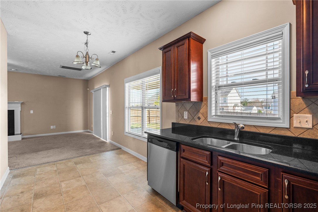 43 Battery Way Bunnlevel, NC 28323 - Photo 28 of 50 a kitchen with granite countertop a sink and a window