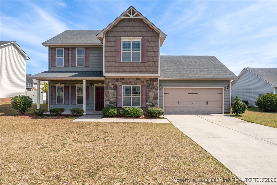 43 Battery Way Bunnlevel, NC 28323 - Photo 3 of 50 a front view of a house with a yard and garage
