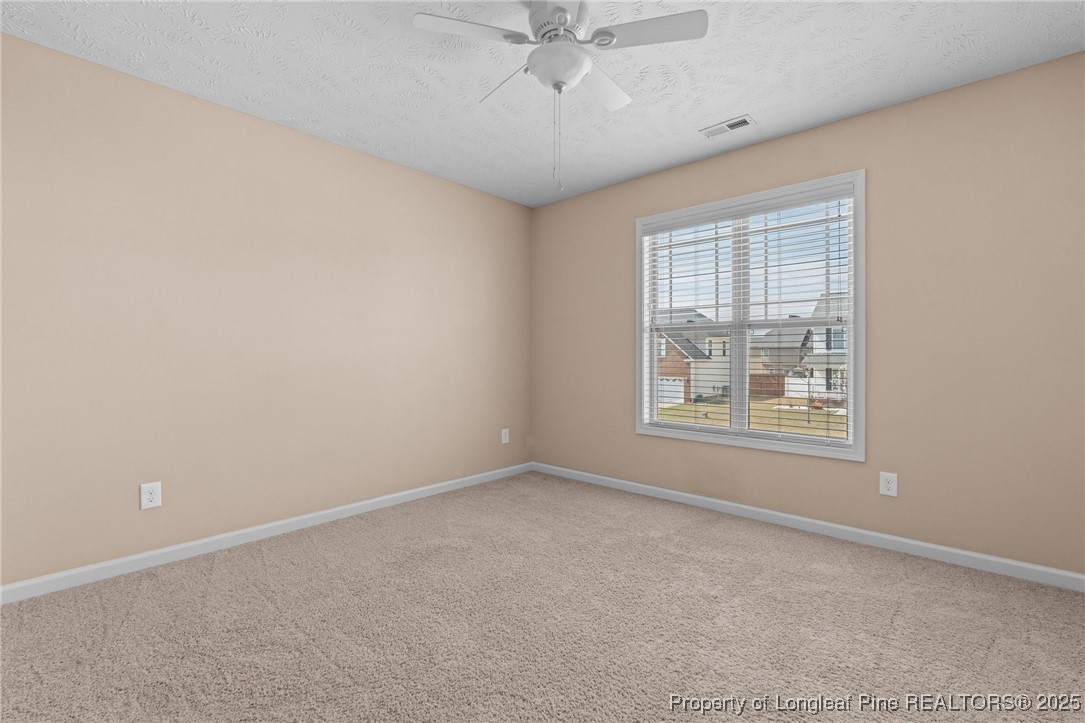 43 Battery Way Bunnlevel, NC 28323 - Photo 35 of 50 an empty room with a ceiling fan and window