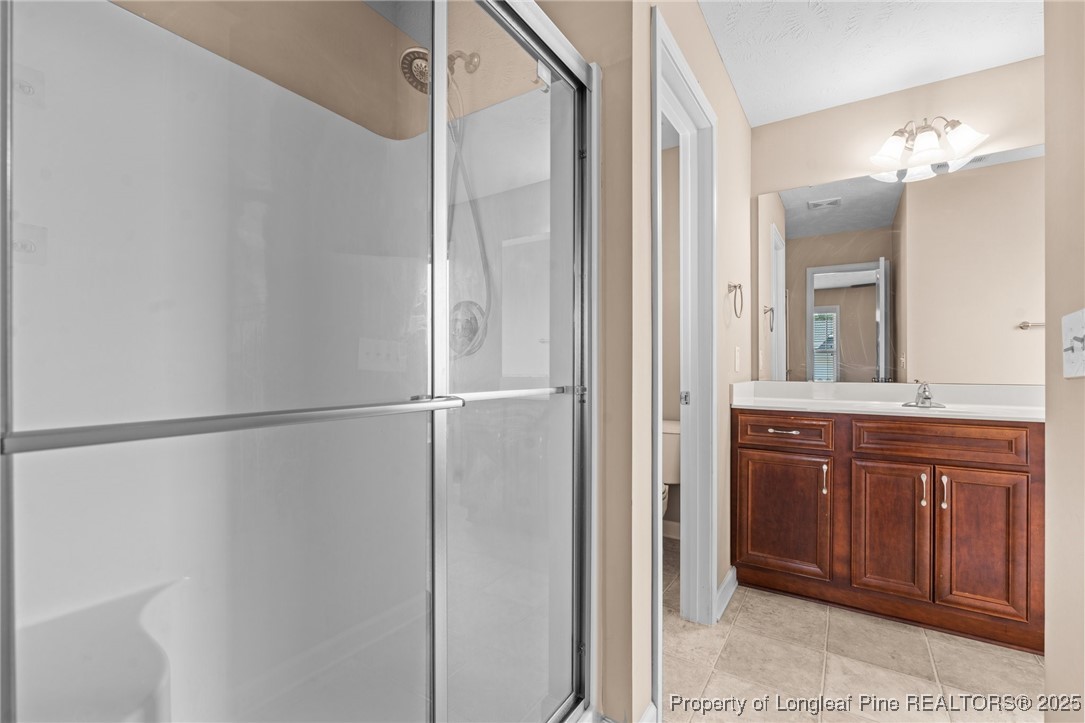 43 Battery Way Bunnlevel, NC 28323 - Photo 41 of 50 a bathroom with a double vanity sink and mirror