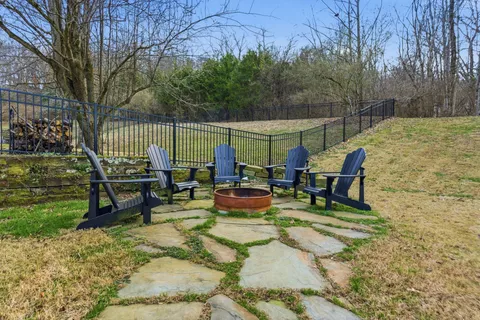 a view of a chair and table in the garden
