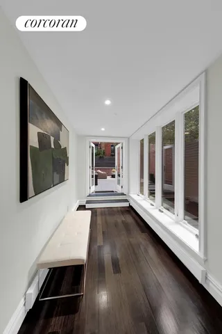 a view of a room with wooden floor and window