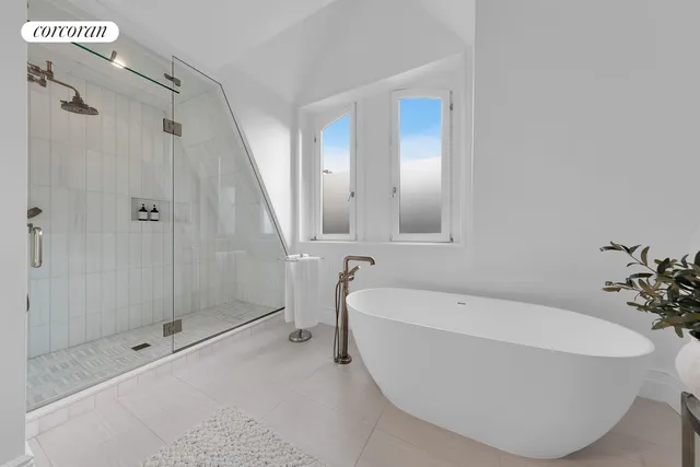 a bathroom with a bathtub and shower