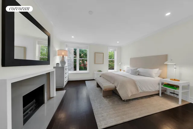 a bedroom with a bed and a fireplace