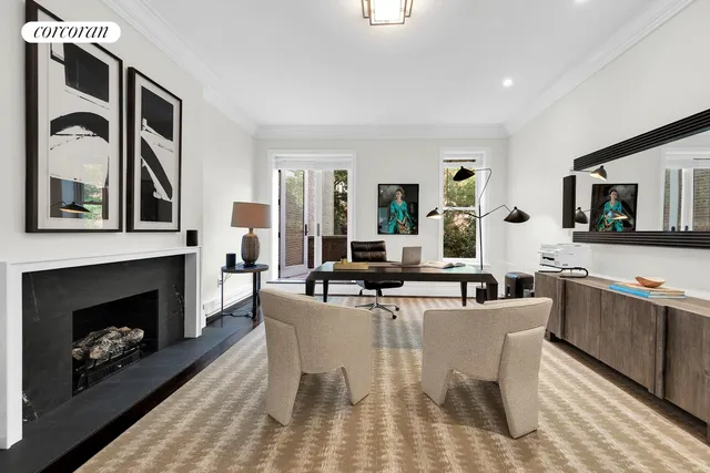 a living room with furniture a fireplace and kitchen view