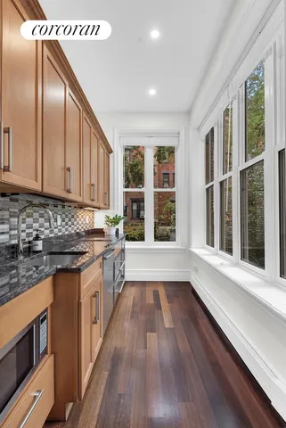 a kitchen with stainless steel appliances granite countertop a stove and a sink