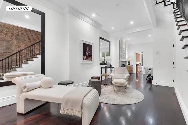 a living room with furniture a wooden floor and a chandelier