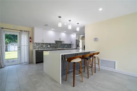 a kitchen with a table and chairs in it