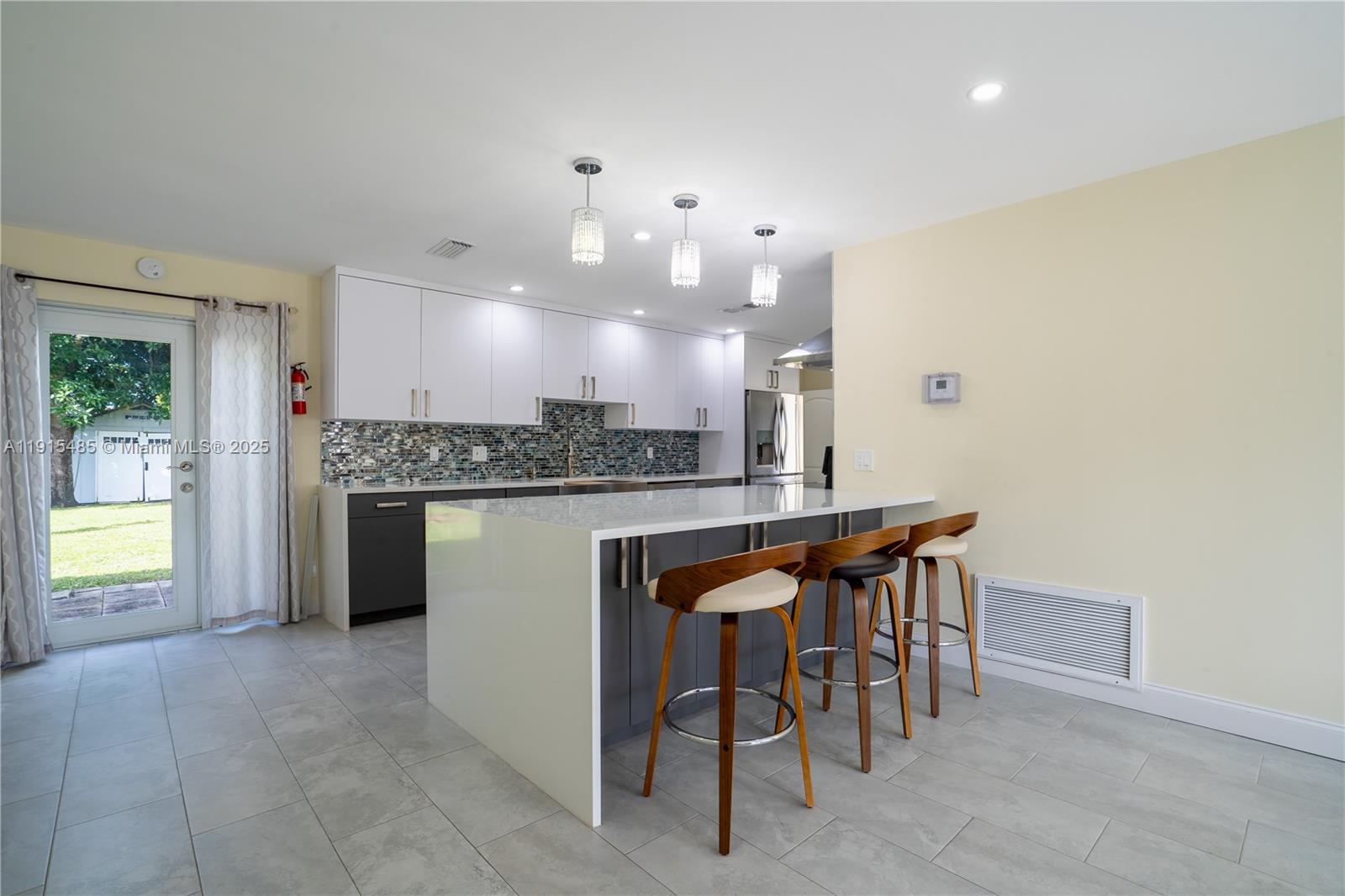 2631 Northwest 47th Avenue Lauderhill, FL 33313 - Photo 2 of 10 a kitchen with a table and chairs in it