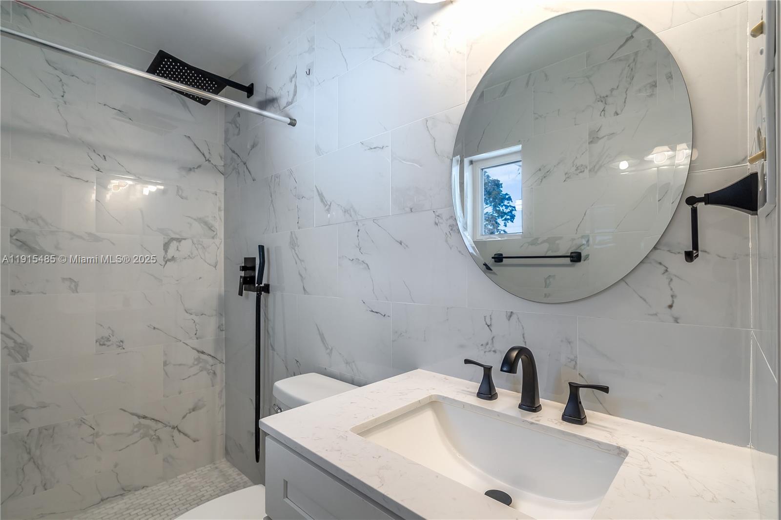 2631 Northwest 47th Avenue Lauderhill, FL 33313 - Photo 5 of 10 a bathroom with a sink and a mirror