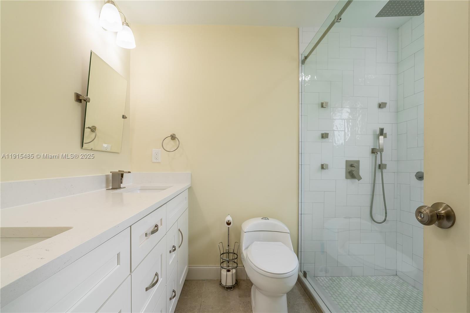 2631 Northwest 47th Avenue Lauderhill, FL 33313 - Photo 6 of 10 a bathroom with a granite countertop sink toilet and shower