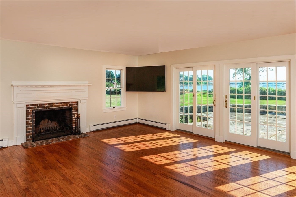 100 Eastern Point Boulevard Gloucester, MA 01930 - Photo 14 of 22 a view of an empty room with a fireplace and a window