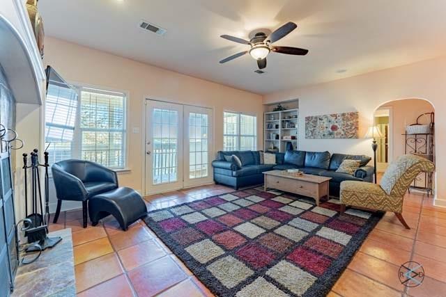 6209 Point La Vista Road Malakoff, TX 75148 - Photo 10 of 38 a living room with furniture a rug and a chandelier