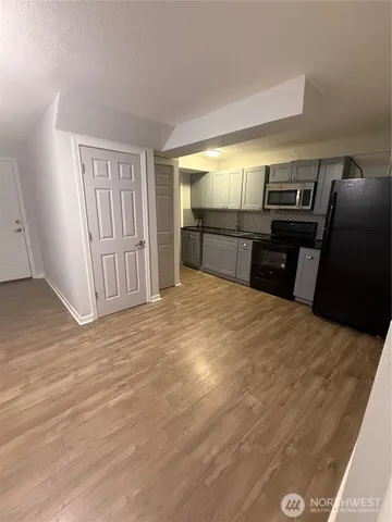 a view of a livingroom with a kitchen