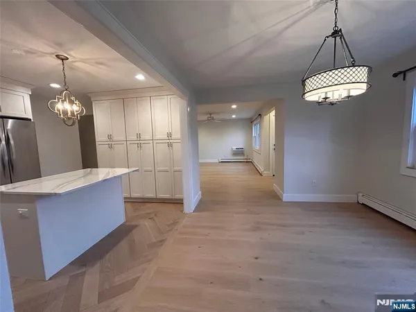 a view of a kitchen with a sink and refrigerator