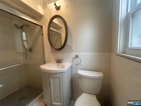 a bathroom with a sink mirror and toilet