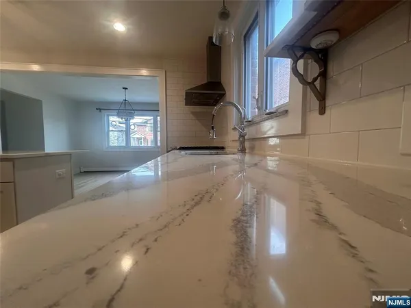 a kitchen with a sink stainless steel appliances and cabinets