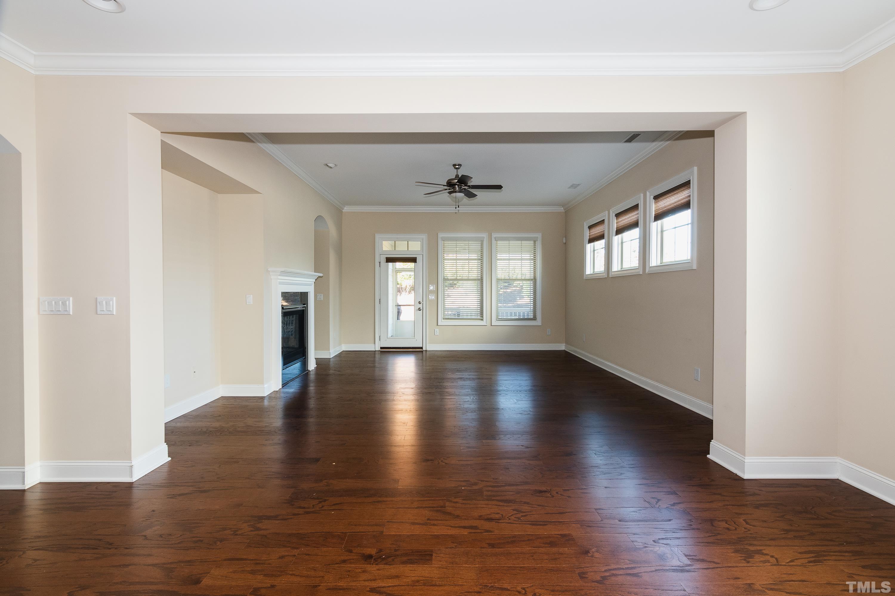 821 Traditions Ridge Drive Wake Forest, NC 27587 - Photo 13 of 14 an empty room with wooden floor and windows