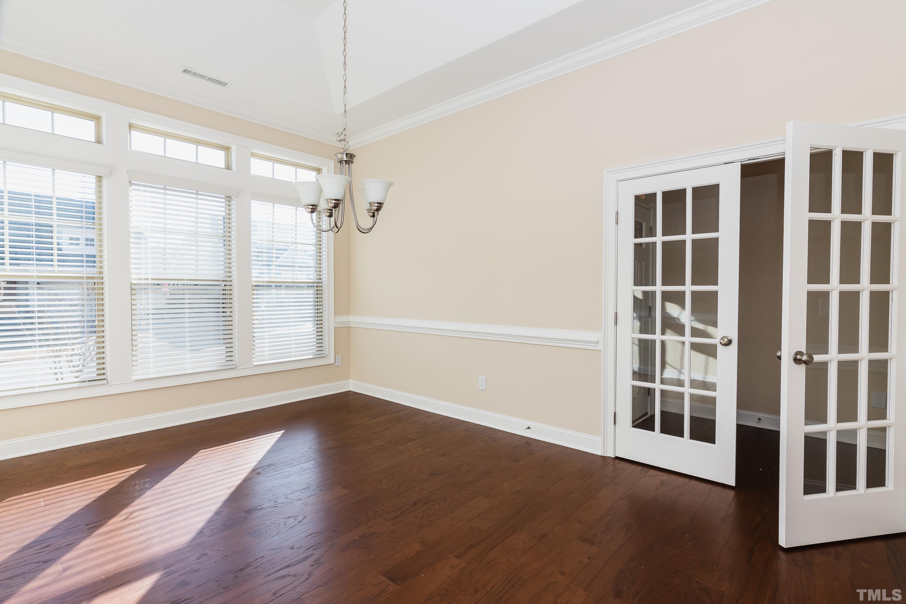 821 Traditions Ridge Drive Wake Forest, NC 27587 - Photo 3 of 14 a view of an empty room with a window and wooden floor