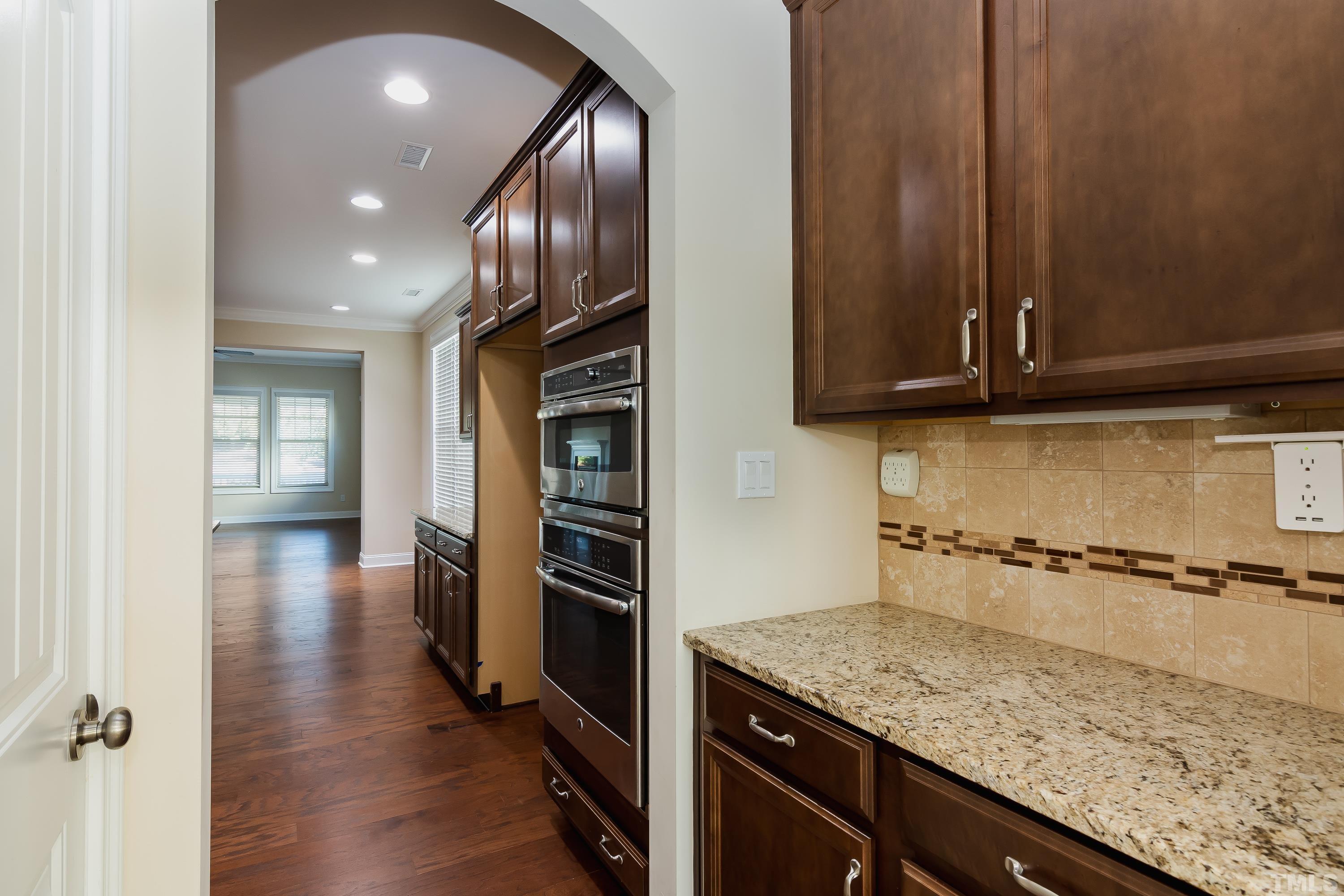 821 Traditions Ridge Drive Wake Forest, NC 27587 - Photo 5 of 14 an empty room with wooden floor and stairs