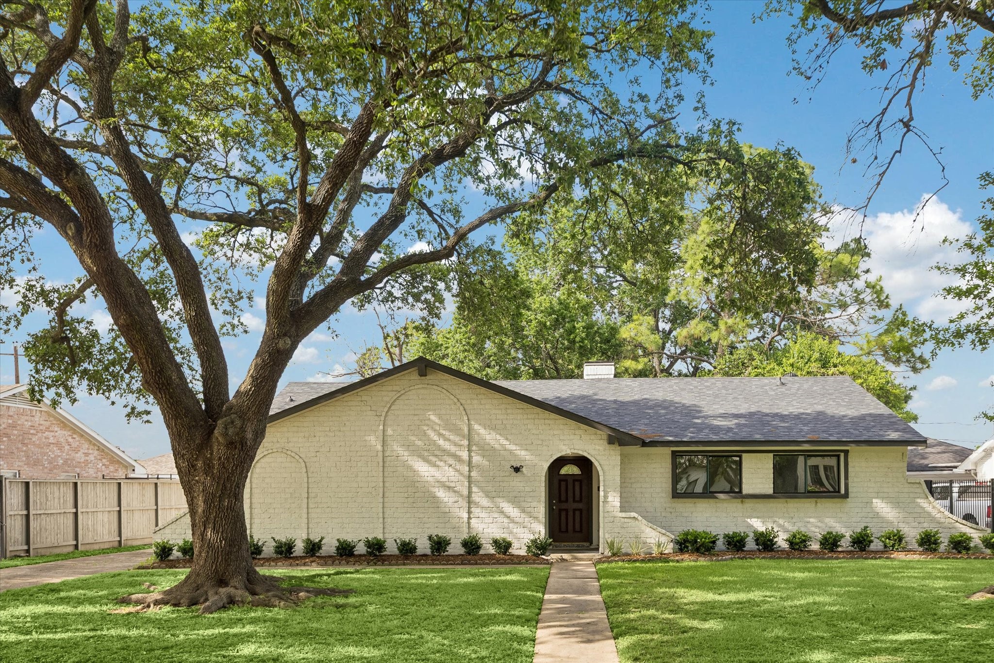 7802 Gulfton Street Houston, TX 77036 - Photo 1 of 20 a front view of a house with a garden