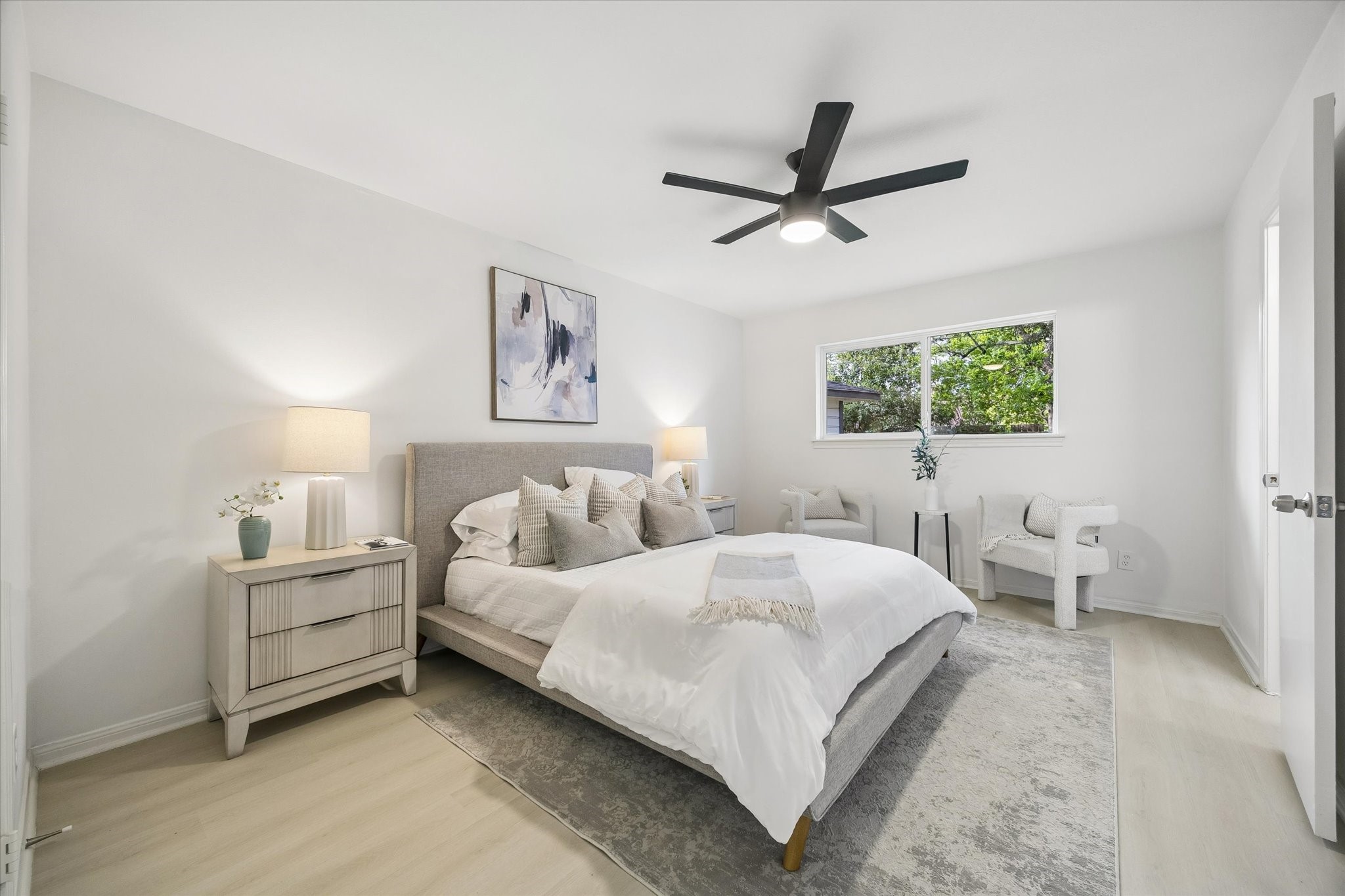 7802 Gulfton Street Houston, TX 77036 - Photo 12 of 20 a bedroom with a bed and a large window