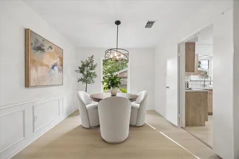 a dining room with furniture and window