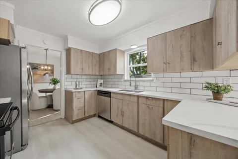 a kitchen with sink cabinets and window