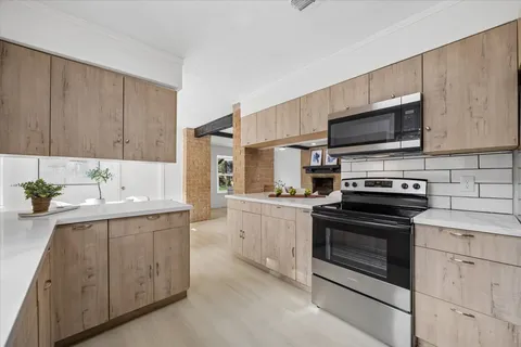 a kitchen with a sink stove and microwave
