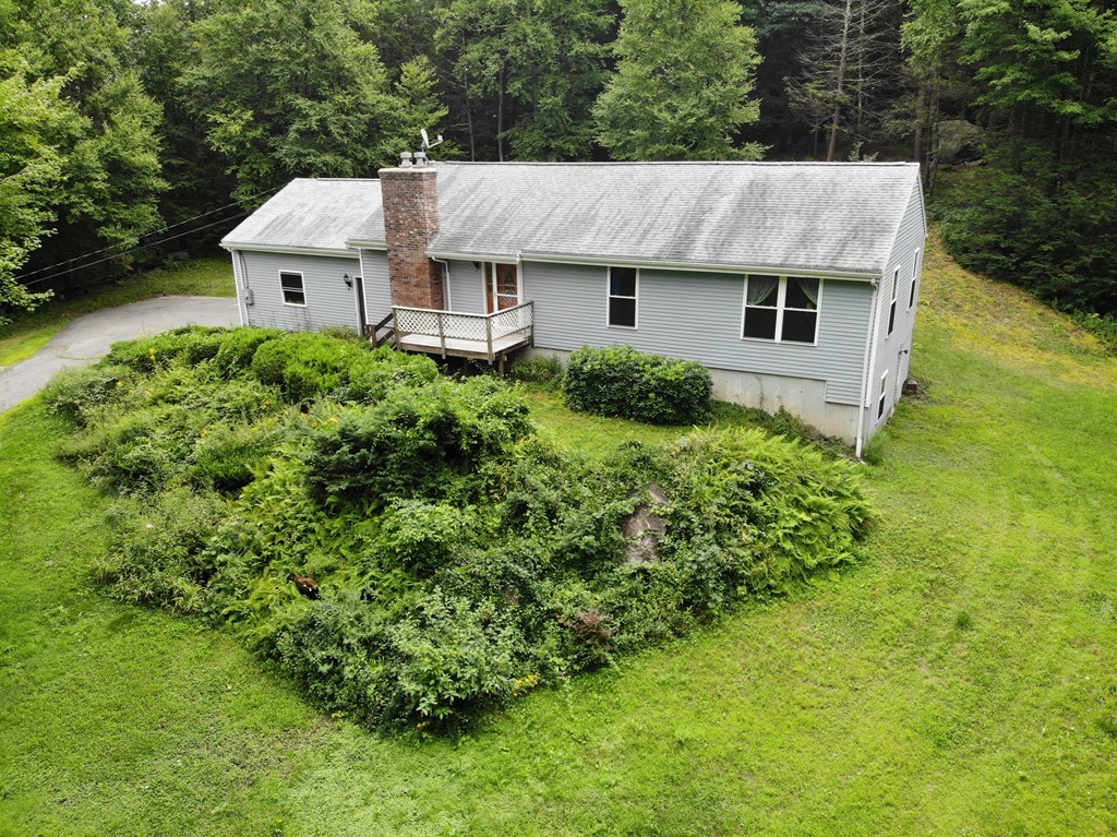 314 Main Road Westhampton, MA 01027 - Photo 1 of 25 a aerial view of a white house with a yard plants and large tree