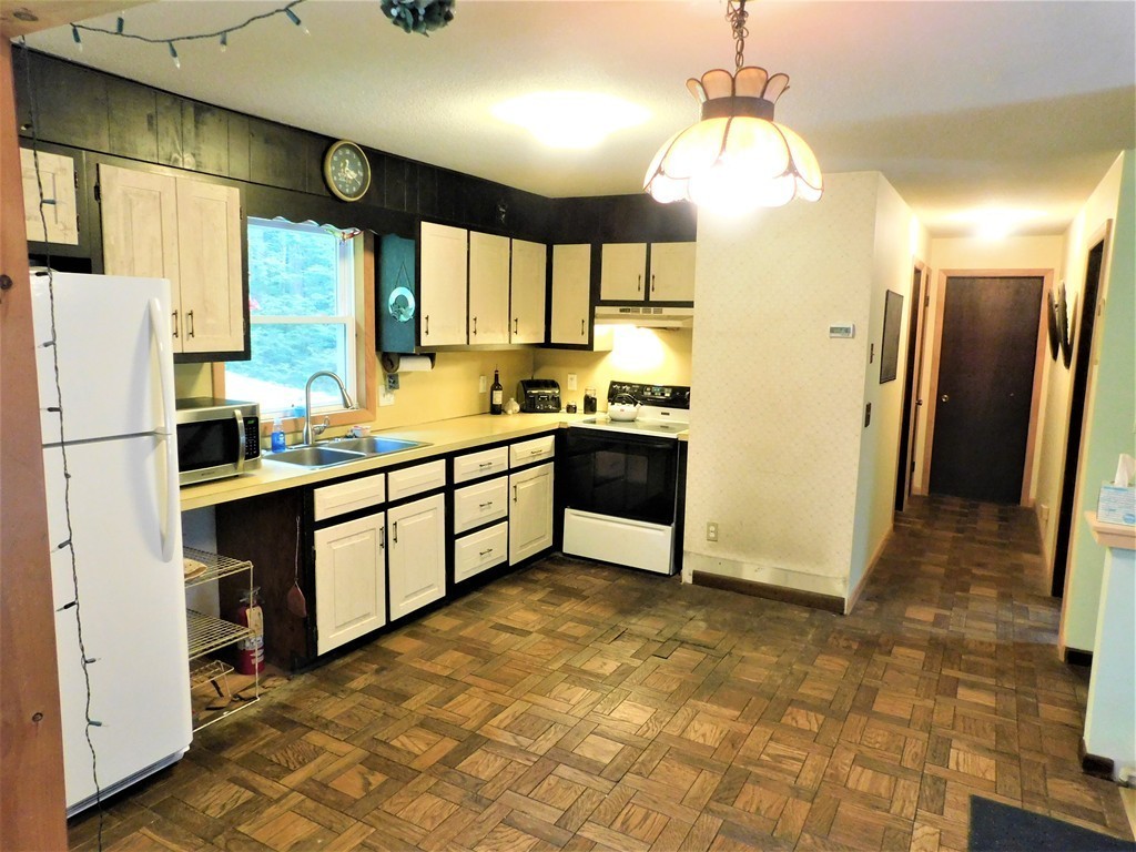 314 Main Road Westhampton, MA 01027 - Photo 18 of 25 a kitchen with stainless steel appliances a refrigerator sink and cabinets