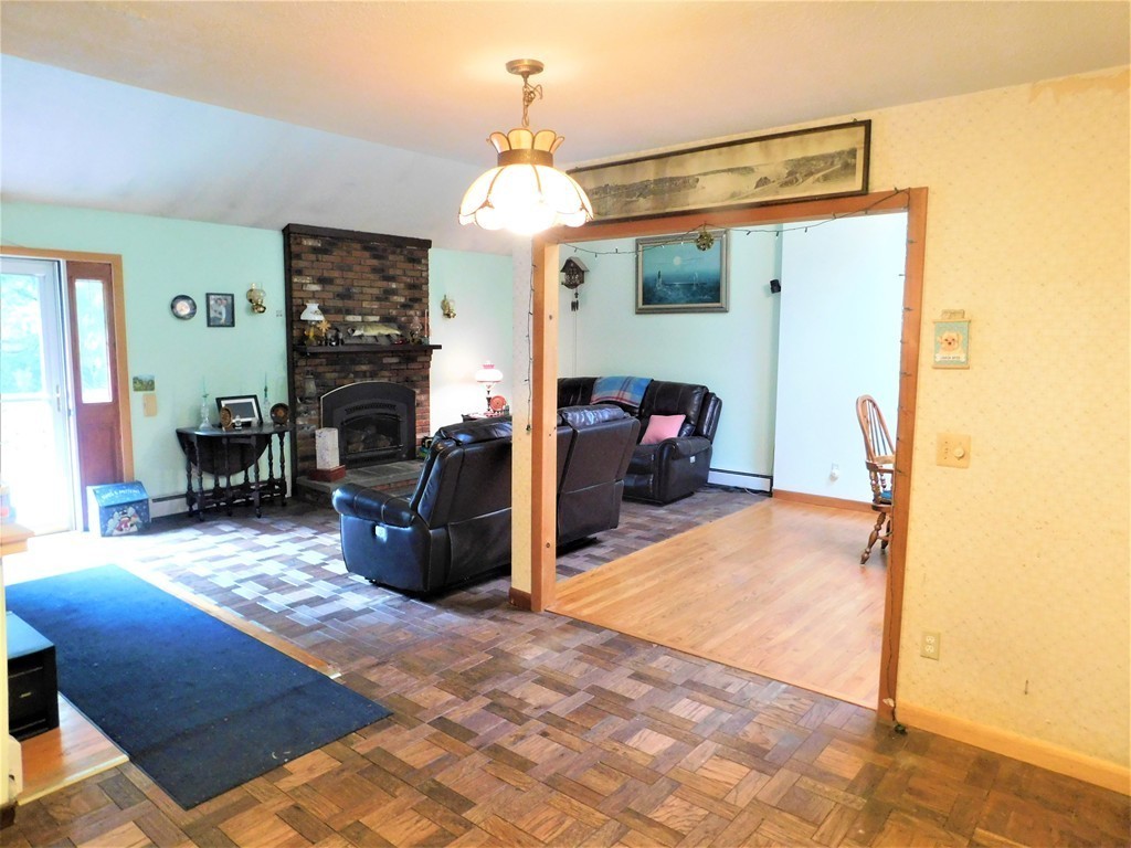 314 Main Road Westhampton, MA 01027 - Photo 19 of 25 a living room with furniture a dining table and a fireplace