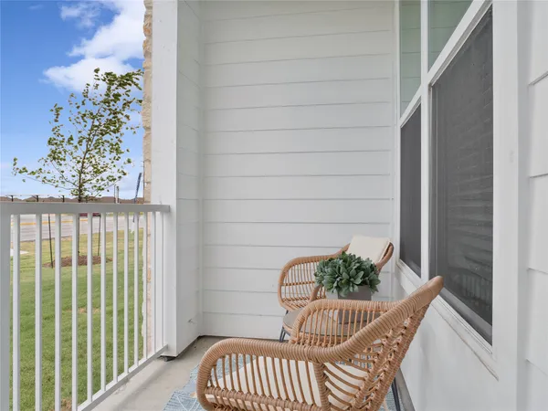a view of a balcony with furniture