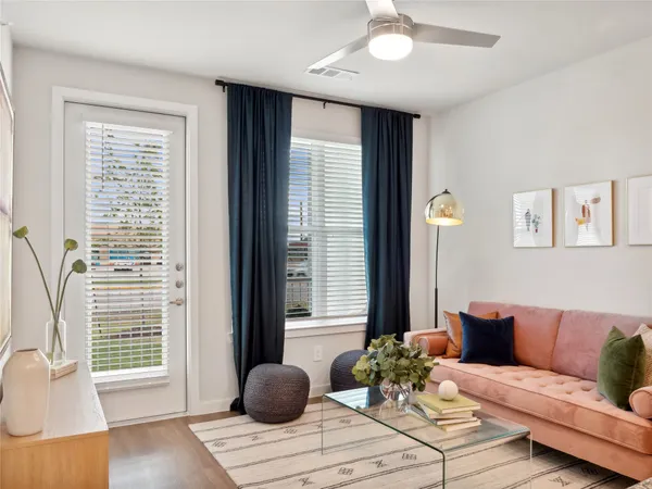 a living room with furniture and wooden floor