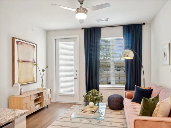 a living room with furniture and window with wooden floor